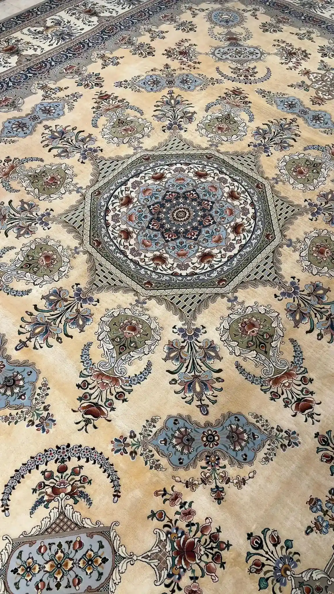 Close-up of the corner design of an artisan Isfahan rug, highlighting the intricate floral patterns in silk and wool.